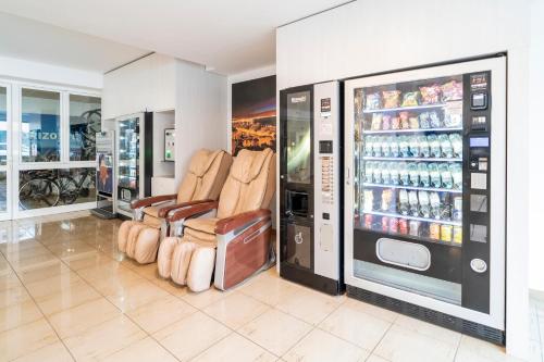 a store with two chairs and a soda machine at Hotel Amic Horizonte in Palma de Mallorca