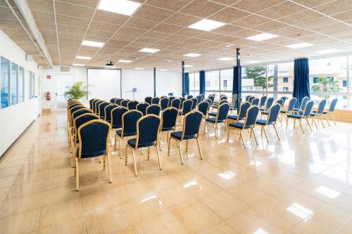 a room with rows of chairs in a building at Hotel Amic Horizonte in Palma de Mallorca