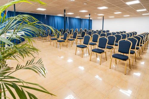 a row of chairs in a room with blue chairs at Hotel Amic Horizonte in Palma de Mallorca
