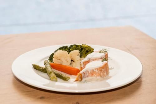 a plate of food with vegetables on a table at Hotel Amic Horizonte in Palma de Mallorca