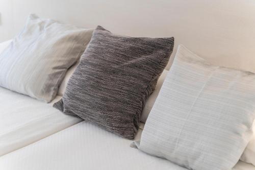 three pillows sitting on top of a bed at Hotel Amic Horizonte in Palma de Mallorca