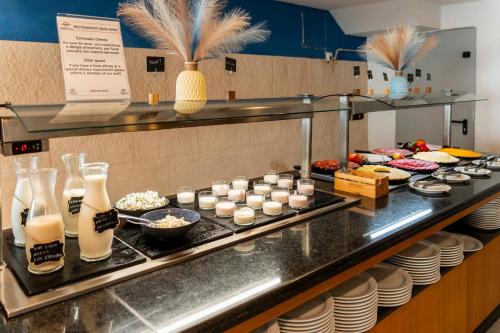 a buffet line with food in a restaurant at Hotel Amic Horizonte in Palma de Mallorca
