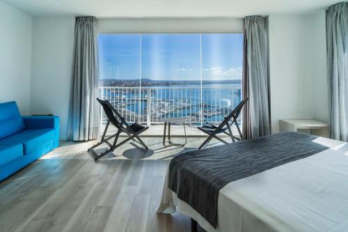 a hotel room with a bed and a view of the water at Hotel Amic Horizonte in Palma de Mallorca