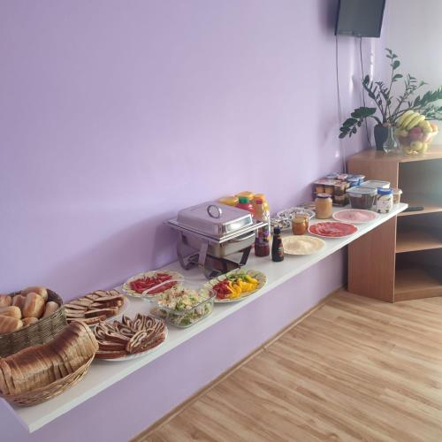 a buffet with many different types of food on a counter at Penzion Zajíček in Zaječí