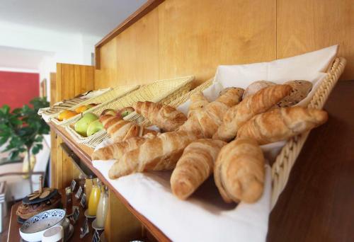 a bunch of breads and croissants on a counter at Quinta do Canal in Vila Nova de Milfontes