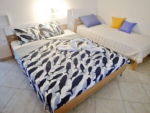 two beds sitting next to each other in a bedroom at Apartments in Baric Draga 38513 in Barić Draga