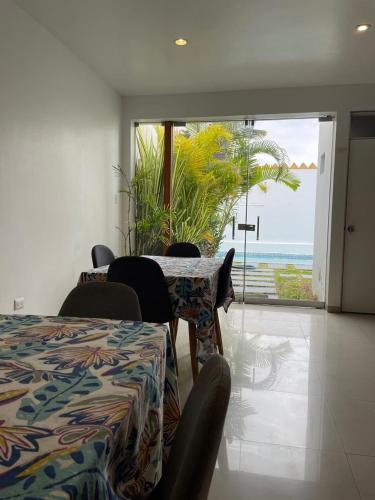 a room with a table and chairs with a view of the ocean at Killamoon House Paracas in Paracas