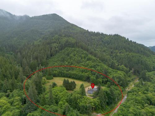 an aerial view of a house in the middle of a mountain at Nehalem Coastal Oasis - Secluded Coastal Home with Hot Tub on 14 Acres in Nehalem