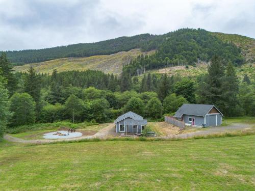 an aerial view of two houses in a field at Nehalem Coastal Oasis - Secluded Coastal Home with Hot Tub on 14 Acres in Nehalem