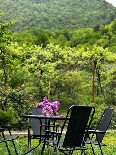 a table with a vase of flowers on it at White House In Borjomi in Borjomi