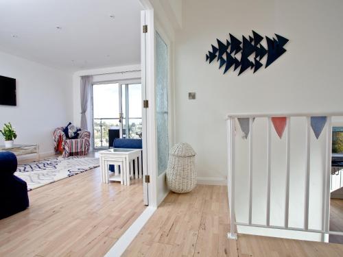 a living room with a door open to a living room at Sea Salt Lodge in Torquay