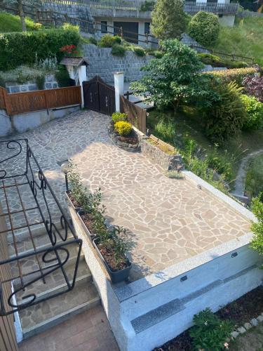 a patio with a bench and some plants at Borzago in Spiazzo