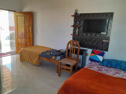 a bedroom with a bed and a chair and a tv at 1st Floor 2Rooms 6Beds Private Stay in Jāmb