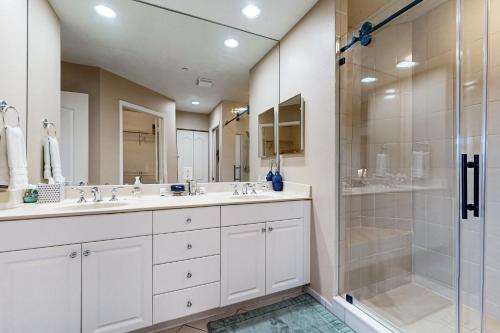 a bathroom with two sinks and a shower at Belle Harbor 13 in Clearwater Beach