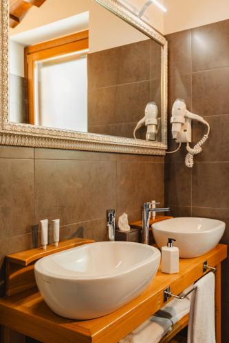 a bathroom with a white sink and a mirror at Tenuta Borgo Santa Cecilia in Gubbio