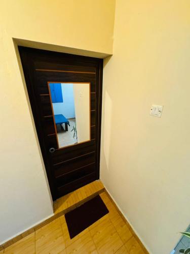 a room with a door with a mirror on it at Parthasarathy Home STay in Trivandrum