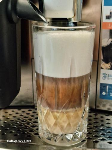 a drink is being made in a blender at RentA Citywalk Flat in Kaunas