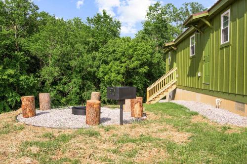 a fire pit in front of a green building at The Lodges at Eden Reserve - Cabin Loop - Near Ark in Williamstown