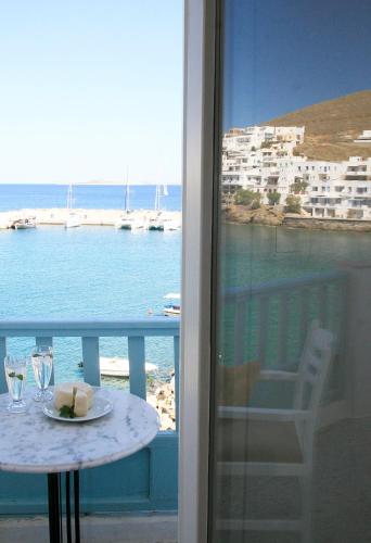 a balcony with a table and a view of the ocean at Paradissos Hotel in Pera Gyalos