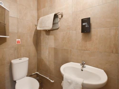 a bathroom with a toilet and a sink at Ptarmigan Lodge in Balmaha