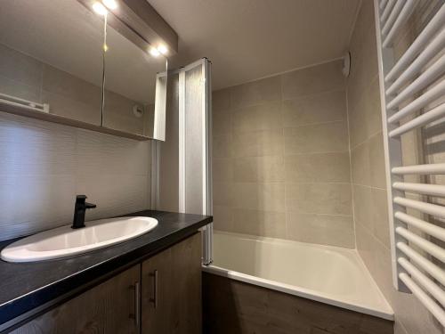 une salle de bain avec un lavabo et une baignoire dans l'établissement Confortable Duplex Mezzanine - Pied des Pistes et Balcon - FR-1-642-48, à Morillon