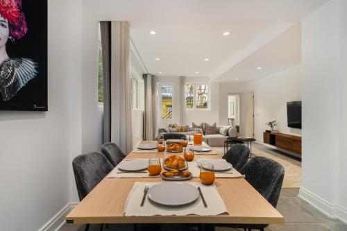 a dining room with a wooden table and chairs at WHome Stylish Oasis near Parque Eduardo VII in Lisbon