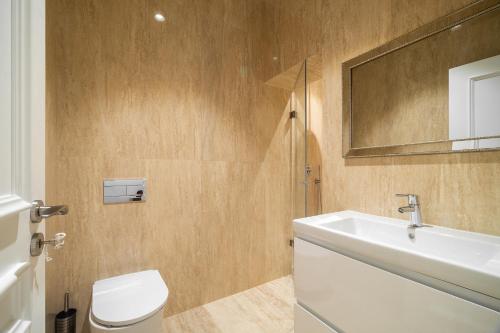 a bathroom with a sink and a toilet and a mirror at WHome Stylish Oasis near Parque Eduardo VII in Lisbon