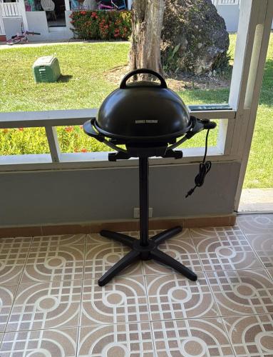 a black pot sitting on a table in front of a window at Dorado Del Mar Villa by PH in Dorado
