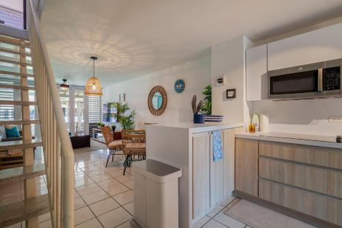 a kitchen with a counter and a living room at Dorado Del Mar Villa by PH in Dorado