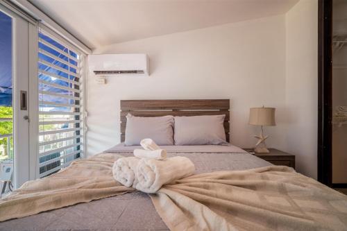 a bedroom with a bed with a towel on it at Dorado Del Mar Villa by PH in Dorado