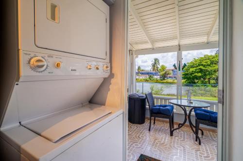 a kitchen with a refrigerator and a table with chairs at Dorado Del Mar Villa by PH in Dorado