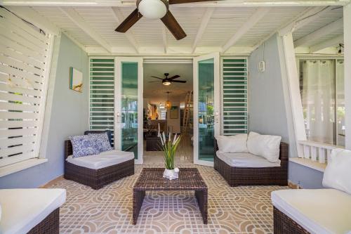 a porch with a couch and chairs and a table at Dorado Del Mar Villa by PH in Dorado