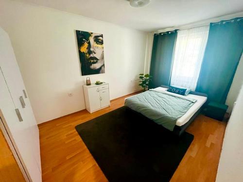 a bedroom with a bed and a large window at Apartman Cañas Zelená Víla in Rimavská Sobota