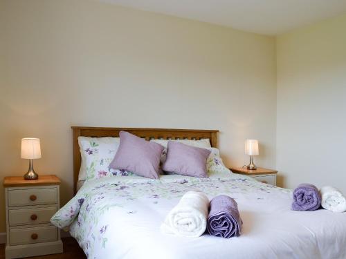 a bedroom with a bed with towels on it at Dolview in Penybont