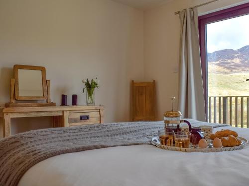 a tray of bread and eggs on a bed with a window at Frith View in White Bridge