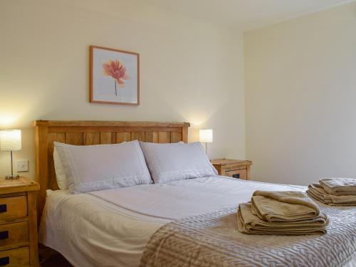 a bedroom with a bed with towels on it at Frith View in White Bridge