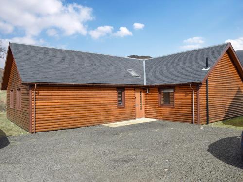 a large wooden building with a garage at Frith View in White Bridge