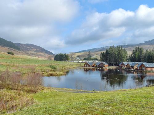 a lake with houses in the middle of a field at Frith View in White Bridge
