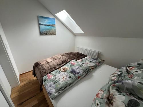 a bedroom with two beds and a picture on the wall at Cityapartments Reutte-Mühl in Reutte