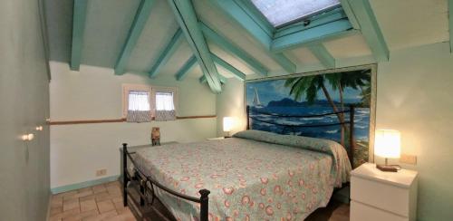 a bedroom with a bed and a painting on the wall at Terrazza sul Mare in Lido di Camaiore