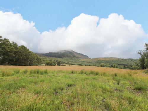a field with a mountain in the background at Little Luxe Lodges 2 in Coillemore