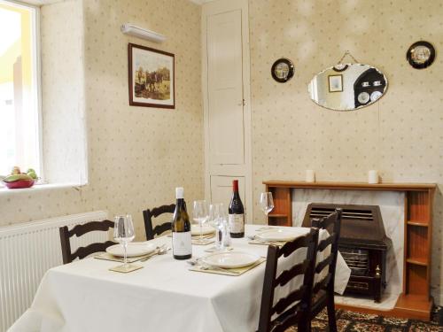 a table with a white table cloth and wine bottles at Number 4 in Llandeilo