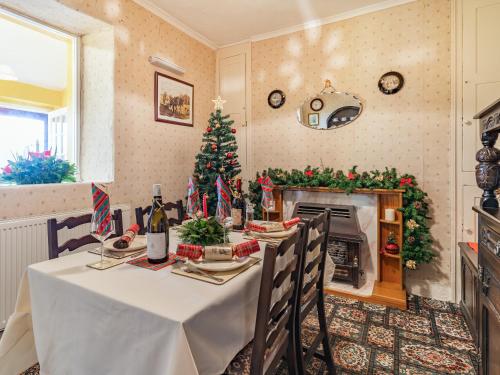 a dining room with a table and a christmas tree at Number 4 in Llandeilo