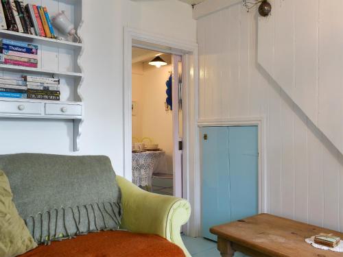 a living room with a couch and a table at The Cottage in St Ives