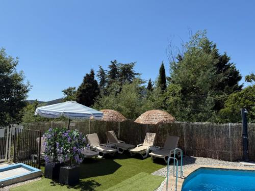 a backyard with chairs and umbrellas and a pool at Domaine Le Rocher d Argent avec Piscine Extérieur ,Jacuzzi Intérieur et Salle de jeux in Berre-les Alpes