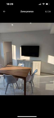 a dining room with a wooden table and chairs at Dany's Home Venus in Giovinazzo