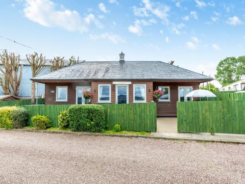 a small house with a fence in front of it at The Stables in Forden