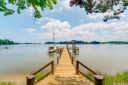 a dock with a boat on the water at 7 and Acre Private Waterfront Gem in Colonial Beach in Colonial Beach