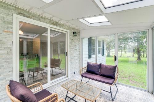 a screened porch with chairs and a table at 7 and Acre Private Waterfront Gem in Colonial Beach in Colonial Beach