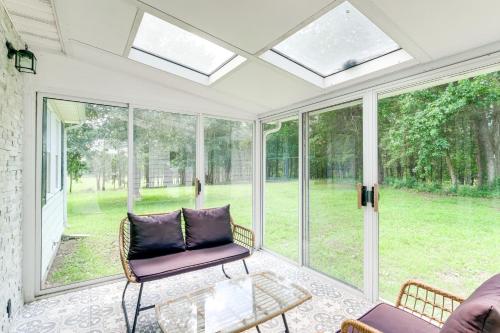 a screened in porch with a couch and a table at 7 and Acre Private Waterfront Gem in Colonial Beach in Colonial Beach